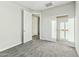 Bedroom with neutral carpet, a closet with sliding doors, and white baseboards at 31824 N 221St Dr, Wittmann, AZ 85361