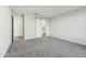 Bedroom with neutral carpet and paint and a sliding barn door to the bathroom at 31824 N 221St Dr, Wittmann, AZ 85361