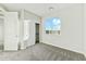 Bedroom with neutral carpet, a closet with sliding doors, and a large window at 31824 N 221St Dr, Wittmann, AZ 85361