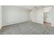 Bedroom with neutral carpet and paint and a sliding barn door to the bathroom at 31824 N 221St Dr, Wittmann, AZ 85361