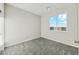 Bedroom with neutral carpet, white walls, and a large window with beautiful mountain views at 31824 N 221St Dr, Wittmann, AZ 85361