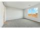 Bedroom with neutral carpet and paint and a bright window with an outside view at 31824 N 221St Dr, Wittmann, AZ 85361