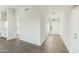 Foyer features gray wood-look floors, white walls, and an entry door with a pendant light above it at 31824 N 221St Dr, Wittmann, AZ 85361