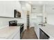 Modern kitchen featuring stainless steel appliances, light countertops and wood-look floors at 31824 N 221St Dr, Wittmann, AZ 85361