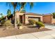Well-manicured desert landscape frames this charming single-story home with a covered entryway and two-car garage at 12364 W Rosewood Ln, Peoria, AZ 85383