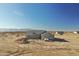 Newly constructed single-story home featuring modern architecture and neutral stucco, set against a desert backdrop at 25721 W Running Deer Trl, Wittmann, AZ 85361