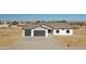 New construction home with two-car garage and desert landscaping at 25721 W Running Deer Trl, Wittmann, AZ 85361