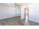 Bright bedroom featuring a ceiling fan, mirrored closet doors, and light wood-look flooring at 4649 N 74Th Pl, Scottsdale, AZ 85251