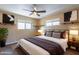 Serene bedroom with neutral tones, a ceiling fan, two bright windows, and minimalist decor at 4649 N 74Th Pl, Scottsdale, AZ 85251