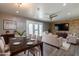 Elegant living room and dining area featuring modern furnishings, stone accent wall, and ample natural light at 4649 N 74Th Pl, Scottsdale, AZ 85251