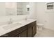 Double vanity bathroom with large mirror and toilet at 22478 W Tonopah Dr, Surprise, AZ 85387