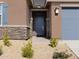 Inviting front entrance with a modern door and stone accents at 22478 W Tonopah Dr, Surprise, AZ 85387