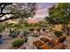 Beautiful backyard with a stone fire pit, desert landscaping, and comfortable lounge chairs at 2744 S First Water Ln, Gold Canyon, AZ 85118