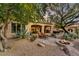Expansive backyard featuring desert landscaping, a fire pit, and an outdoor living area at 2744 S First Water Ln, Gold Canyon, AZ 85118