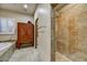 Bright bathroom boasts tile flooring, glass shower enclosure, soaking tub, and wood cabinets at 2744 S First Water Ln, Gold Canyon, AZ 85118