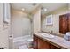 Bathroom features a shower, white tile, and a wooden cabinet with countertop at 2744 S First Water Ln, Gold Canyon, AZ 85118