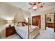 Bright bedroom featuring a decorative bed frame, carpeted floor, and ensuite bathroom at 2744 S First Water Ln, Gold Canyon, AZ 85118