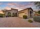 Charming stone home with desert landscaping, brick driveway, and beautiful sunset views at 2744 S First Water Ln, Gold Canyon, AZ 85118