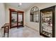 Elegant foyer featuring tile floors, a large arched mirror, and access to the outdoor patio at 2744 S First Water Ln, Gold Canyon, AZ 85118