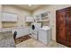 Convenient laundry room with plenty of storage cabinets and a washing machine and dryer at 2744 S First Water Ln, Gold Canyon, AZ 85118