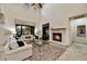 Inviting living room boasts a cozy fireplace and large windows, filling the space with natural light at 2744 S First Water Ln, Gold Canyon, AZ 85118