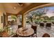Inviting outdoor living area with a built-in grill, comfortable seating, and desert landscaping at 2744 S First Water Ln, Gold Canyon, AZ 85118