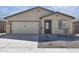 Charming single-story home featuring a two-car garage, desert landscaping, and neutral color palette at 24579 W St Catherine Ave, Buckeye, AZ 85326