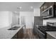 Granite countertops and stainless steel appliances complement this modern kitchen design at 24579 W St Catherine Ave, Buckeye, AZ 85326
