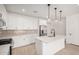 Modern kitchen with white cabinets, island, stainless steel appliances, and pendant lighting at 8320 N 54Th Ln, Glendale, AZ 85302