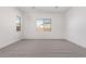 Bedroom with natural lighting, neutral color palette, and soft carpeted floor at 11938 W Parkway Ln, Avondale, AZ 85323