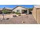 Spacious backyard with gravel, plants and covered patio at 29205 N Yellow Bee Dr, San Tan Valley, AZ 85143