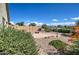 Landscaped backyard with gravel, plants, and bird baths at 29205 N Yellow Bee Dr, San Tan Valley, AZ 85143