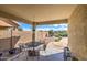 Covered patio with table and chairs, overlooking backyard at 29205 N Yellow Bee Dr, San Tan Valley, AZ 85143