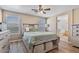 Neutral bedroom featuring wood-look floors, a ceiling fan, and large windows for lots of natural light at 1448 E Poncho Ln, San Tan Valley, AZ 85143