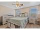 Inviting bedroom boasts wood-look flooring, ceiling fan, neutral walls, and stylish furnishings with backyard access at 1448 E Poncho Ln, San Tan Valley, AZ 85143