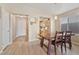 Dining room with a rustic table, hardwood floors, and an open floorplan flows into the adjacent kitchen at 1448 E Poncho Ln, San Tan Valley, AZ 85143