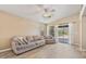 Relaxing living room with lots of natural light, tile floors, comfortable sofa, and backyard access at 1448 E Poncho Ln, San Tan Valley, AZ 85143