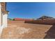 View of a large dirt backyard enclosed by a brick wall at 11937 W Parkway Ln, Avondale, AZ 85323