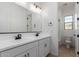 Bright bathroom features double sinks, white cabinetry, and a toilet at 11937 W Parkway Ln, Avondale, AZ 85323