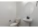 Bright bathroom features a pedestal sink and a toilet at 11937 W Parkway Ln, Avondale, AZ 85323