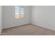 Bedroom with neutral carpet, natural light, and an electrical outlet at 11937 W Parkway Ln, Avondale, AZ 85323