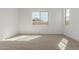 Carpeted bedroom with bright natural light and a modern aesthetic at 11937 W Parkway Ln, Avondale, AZ 85323