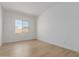 Bedroom with light wood floors, natural light, and an electrical outlet at 11937 W Parkway Ln, Avondale, AZ 85323