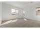 Carpeted bedroom with bright natural light and a modern aesthetic at 11937 W Parkway Ln, Avondale, AZ 85323