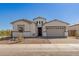 Charming single-story home featuring a brick-paved driveway and a welcoming two-car garage at 11937 W Parkway Ln, Avondale, AZ 85323