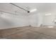 View of a large garage with access door and overhead lighting at 11937 W Parkway Ln, Avondale, AZ 85323