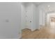 Hallway with laminate flooring, white walls, and white doors at 11937 W Parkway Ln, Avondale, AZ 85323
