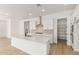 Bright kitchen with stainless steel appliances, a large island, and white cabinets at 11937 W Parkway Ln, Avondale, AZ 85323