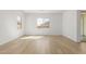 Light filled living room with wood-look vinyl plank flooring and a modern aesthetic at 11937 W Parkway Ln, Avondale, AZ 85323
