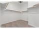 Spacious walk-in closet with carpet and built-in shelving, offering ample storage space at 11937 W Parkway Ln, Avondale, AZ 85323